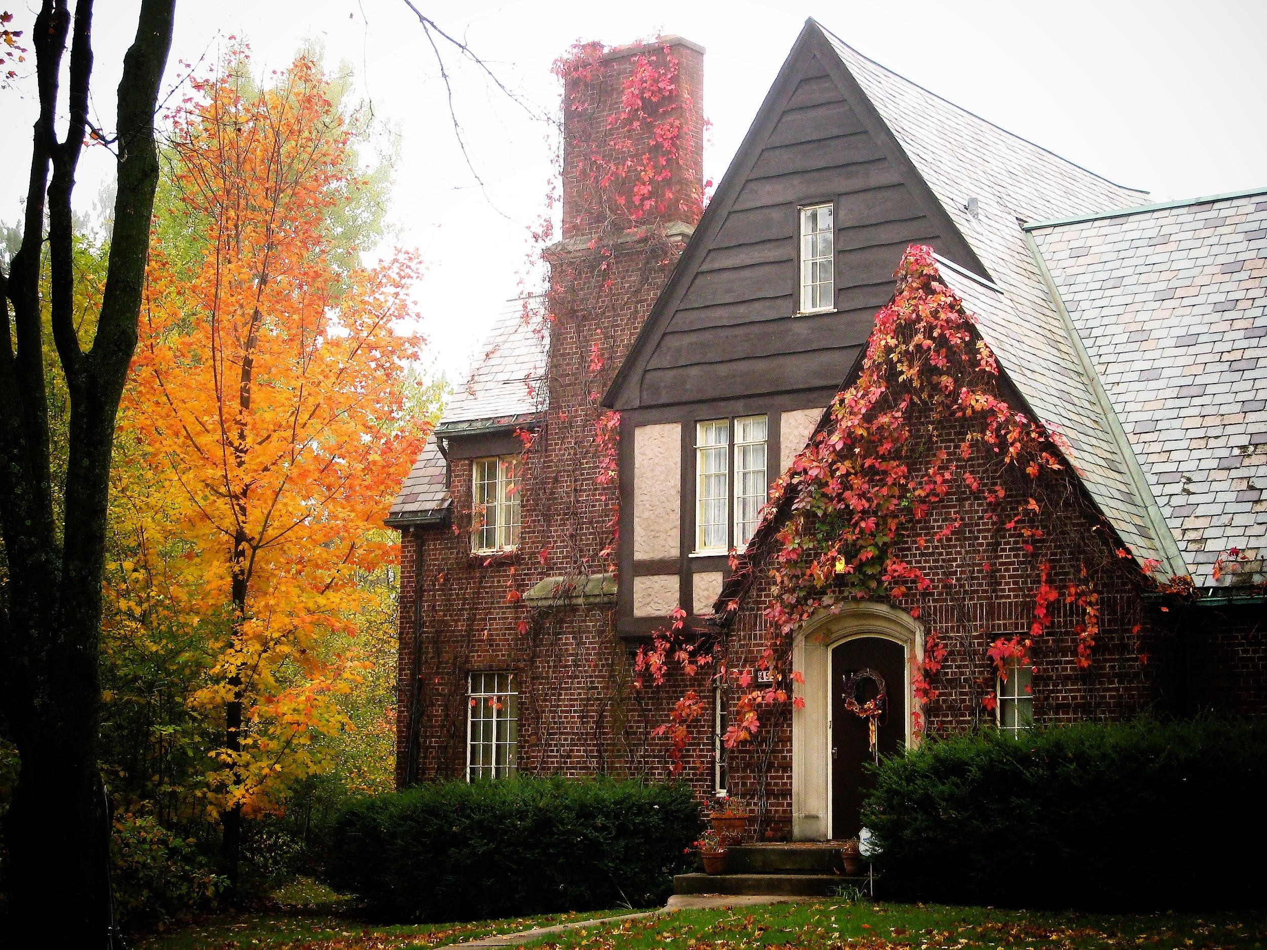 red brick house with red and yellow foliage